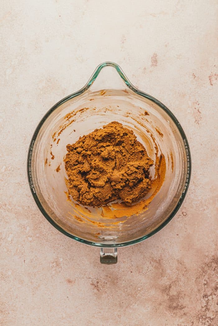Gingerbread thumbprint dough mixed together in a glass mixing bowl.