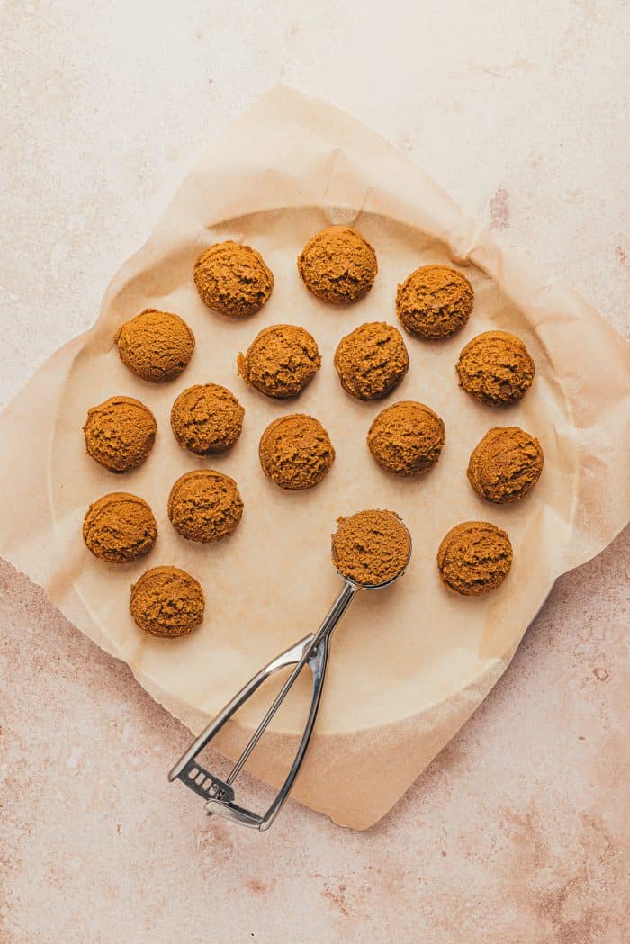 Scoops of gingerbread thumbprint cookie dough on a plate.