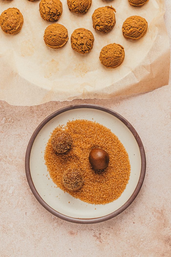 Balls of gingerbread thumbprint cookie dough rolled in sugar.