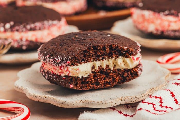 A chocolate Whoopie Pie with a bite taken out of it on a plate.