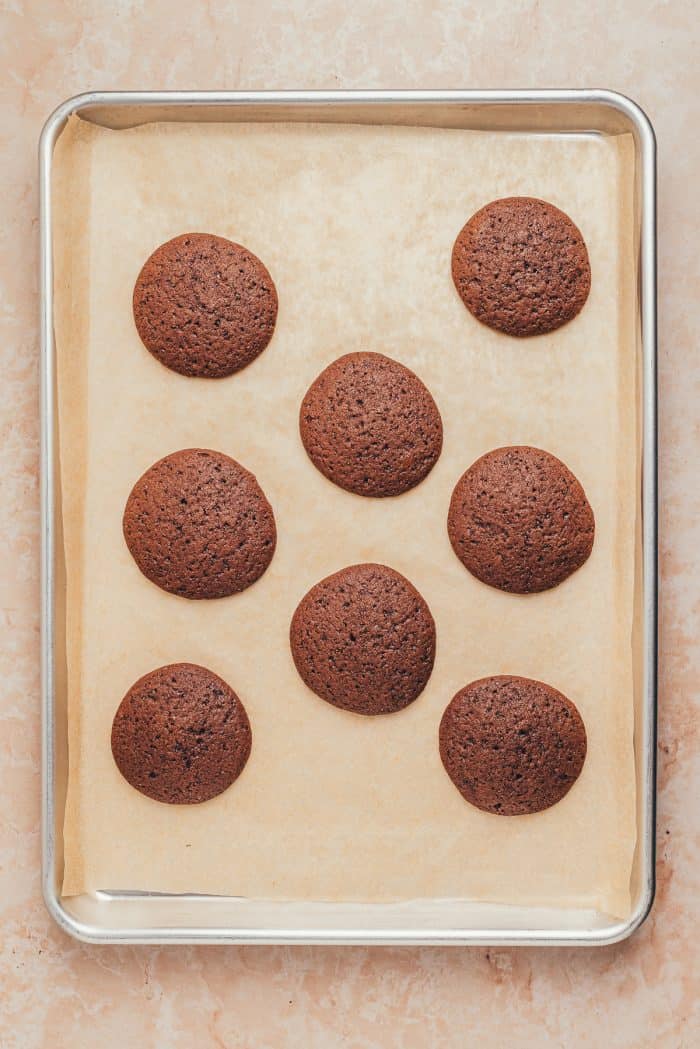 Baked Whoopie pies on a baking sheet with parchment paper.