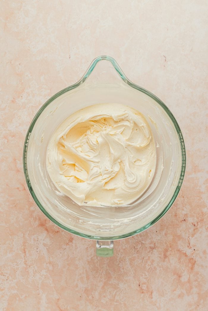 The buttercream frosting in a glass mixing bowl.