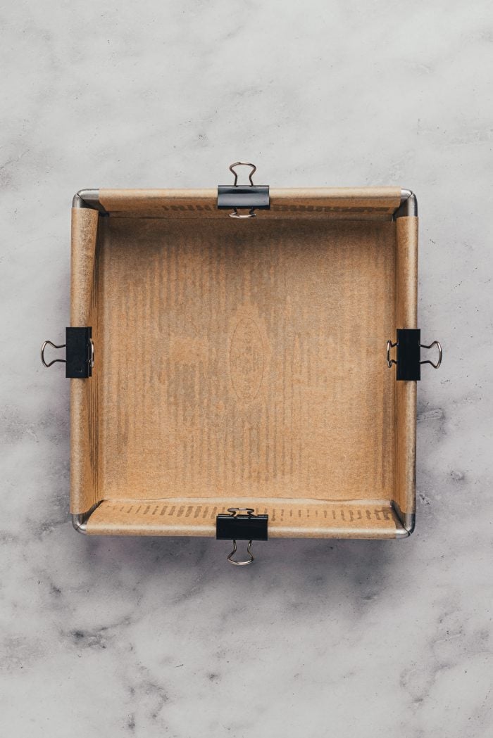 A square baking pan with parchment paper.