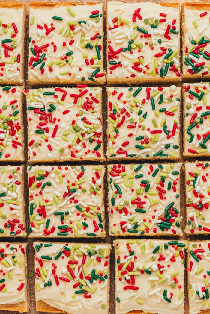 Frosted sugar cookie bars sliced showing the top of the bar with sprinkles.