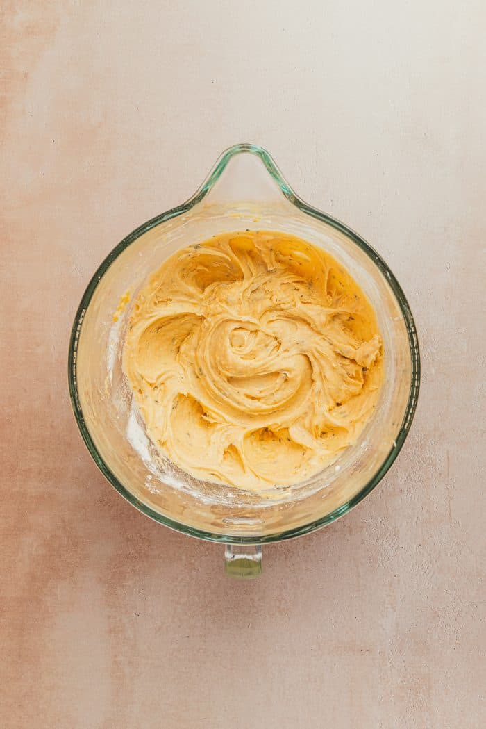 A glass mixing bowl with the lemon pound cake batter.