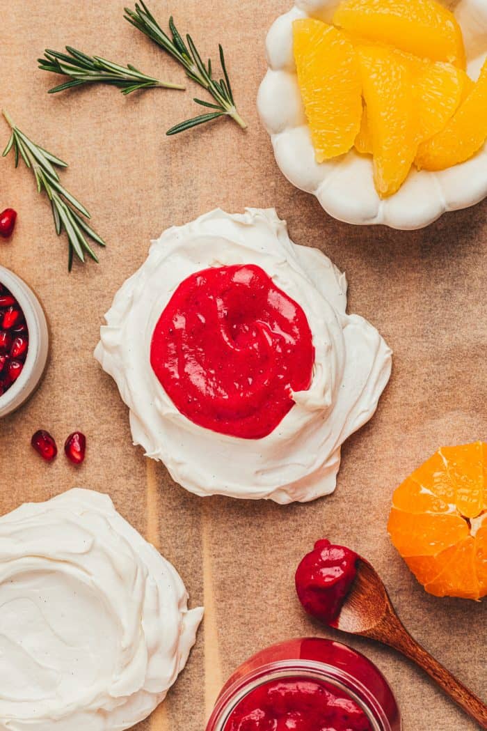 A mini pavlova with cranberry curd and a mini pavlovas without any filling.