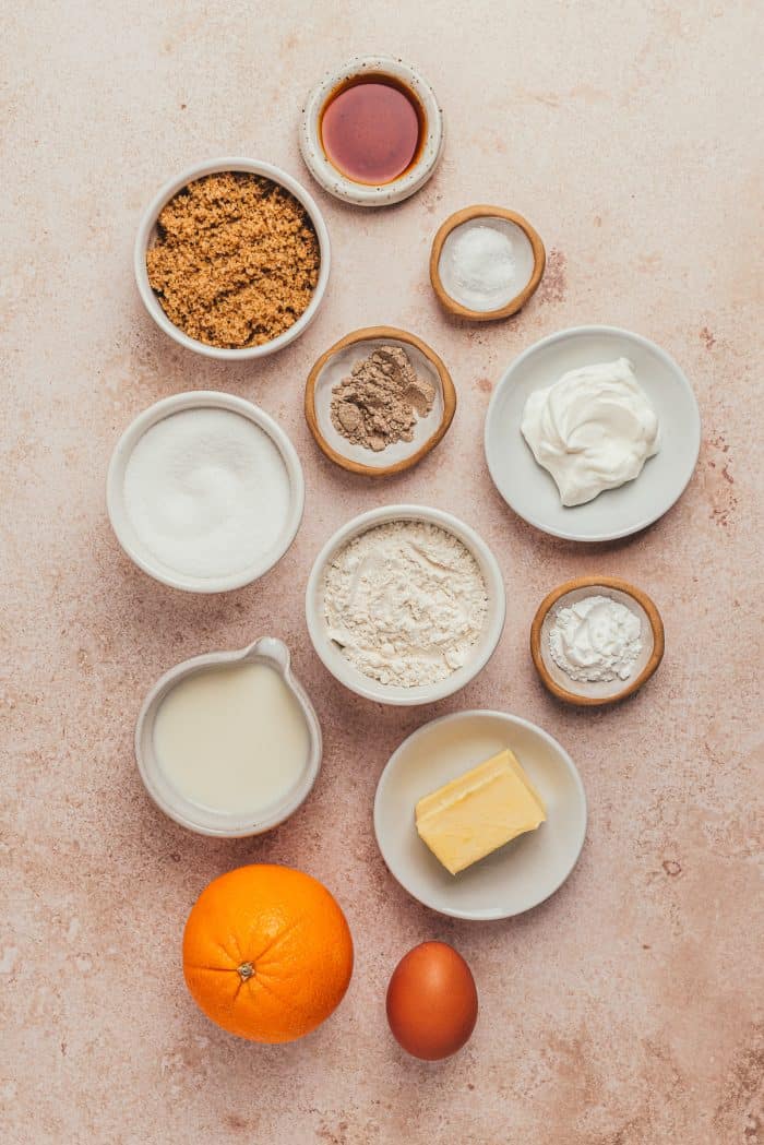 A variety of bowls with the ingredients needed to make orange upside down cake.