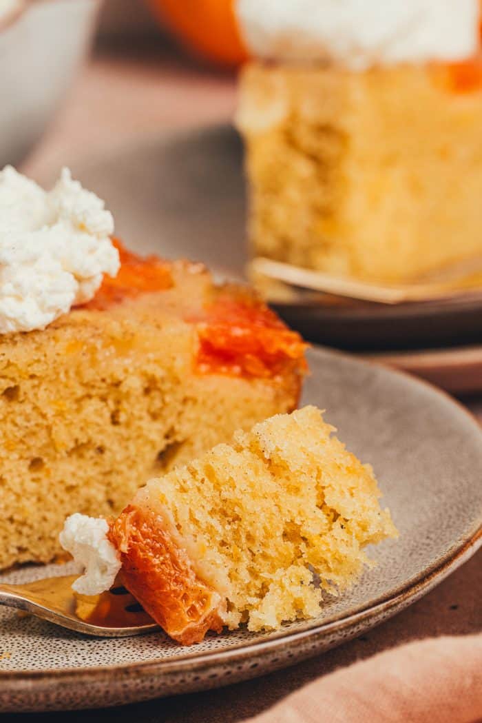 A slice of upside down orange cake on two plates.