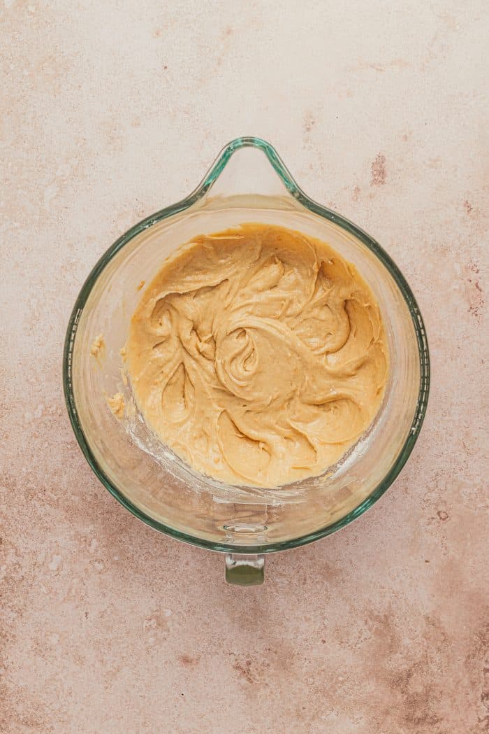 A glass mixing bowl with the cake batter in it.