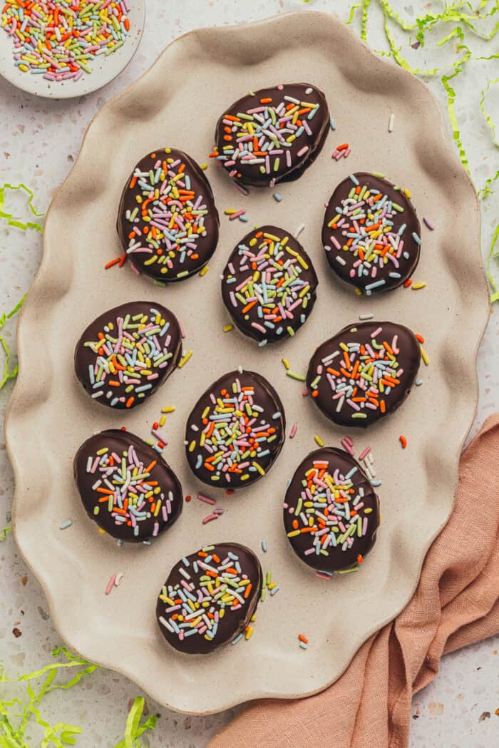 A few homemade chocolate Easter eggs scattered on a plate.