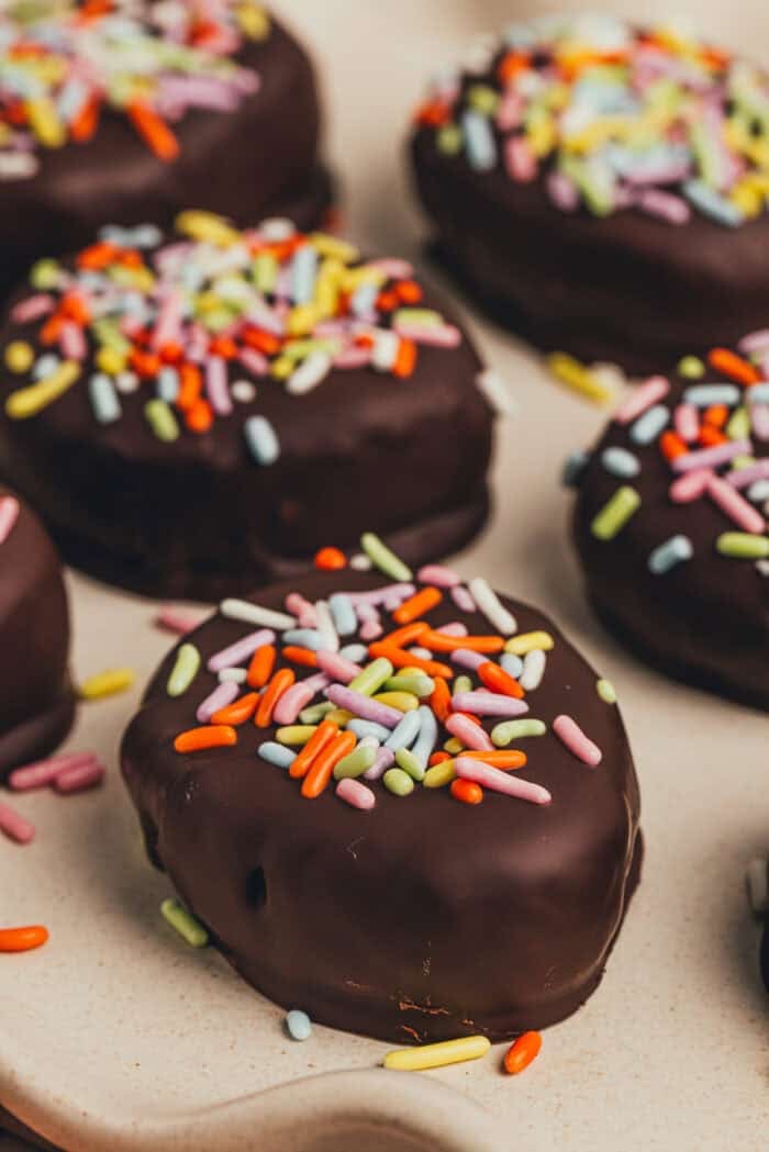 A few homemade chocolate Easter eggs scattered on a plate.