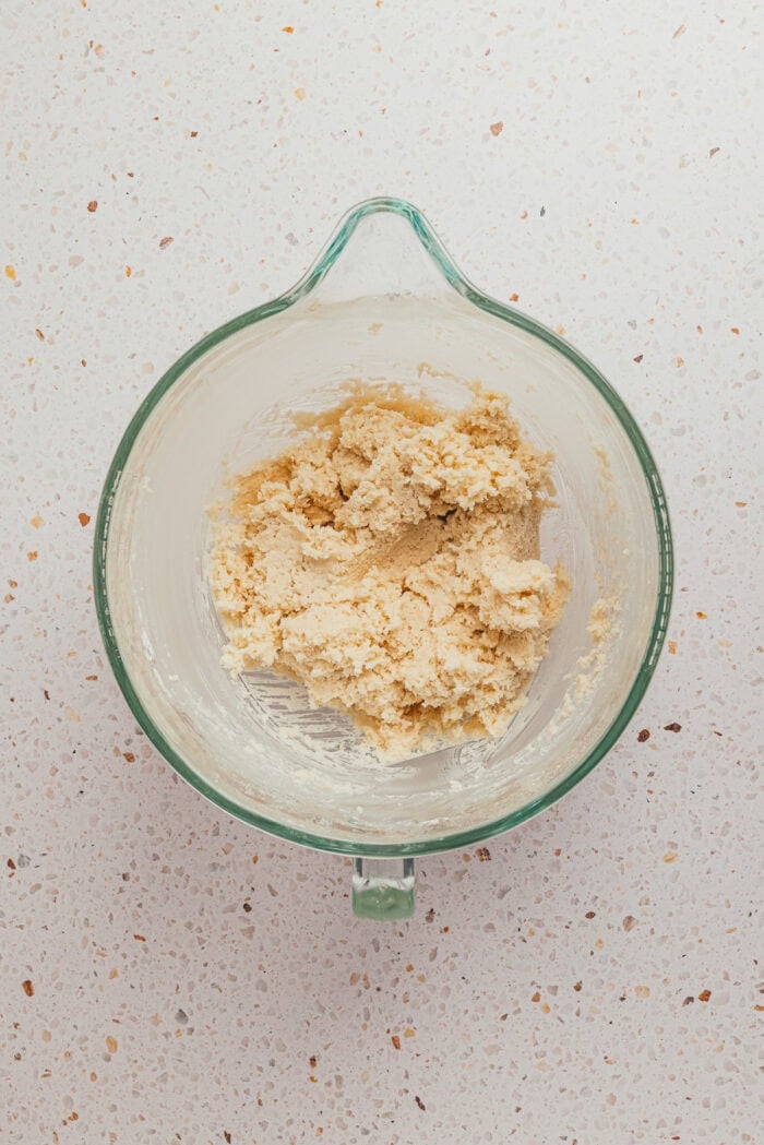 The coconut flakes filling mixed together in a glass mixing bowl.