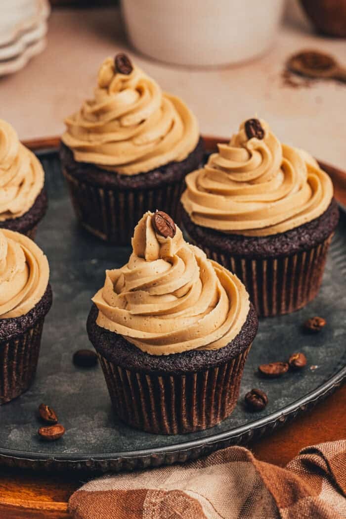 A couple of chocolate espresso cupcakes on a platter.