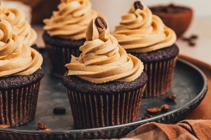 A couple of chocolate espresso cupcakes on a platter.