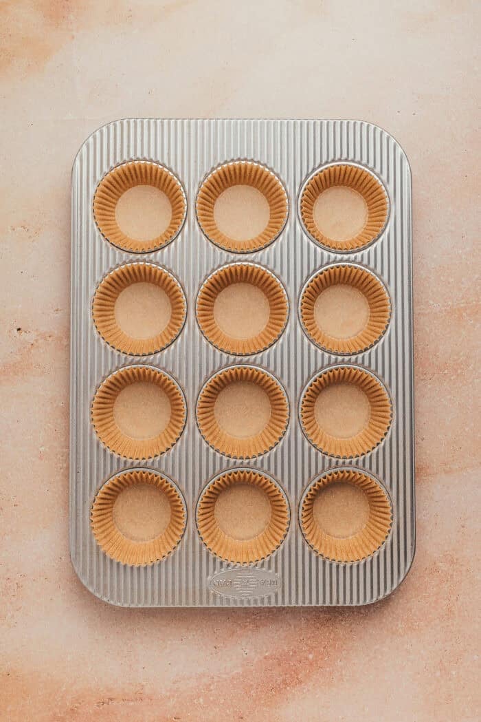 A cupcake pan with cupcake liners.