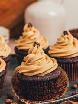 A couple of chocolate espresso cupcakes on a platter.