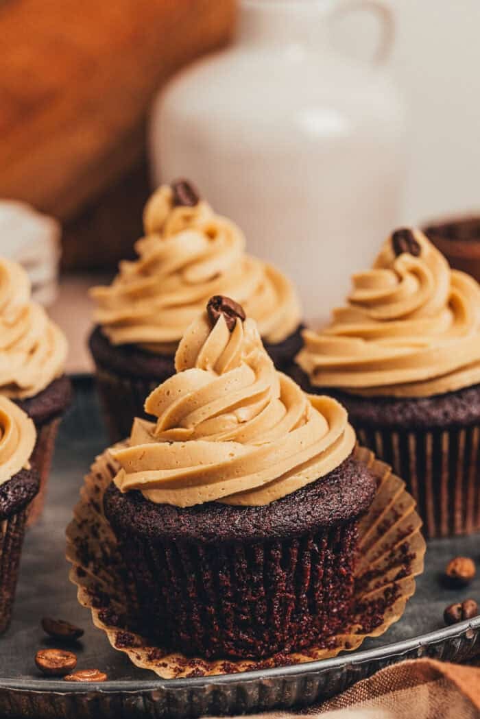 A couple of chocolate espresso cupcakes on a platter.