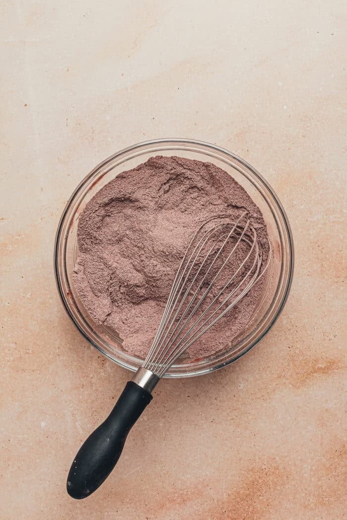 A glass bowl with the dry ingredients to make chocolate espresso cupcakes.