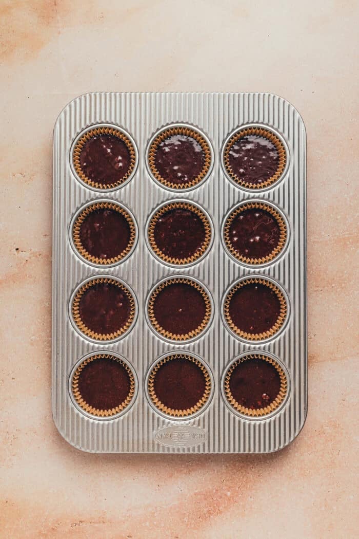 A cupcake pan with cupcake batter.