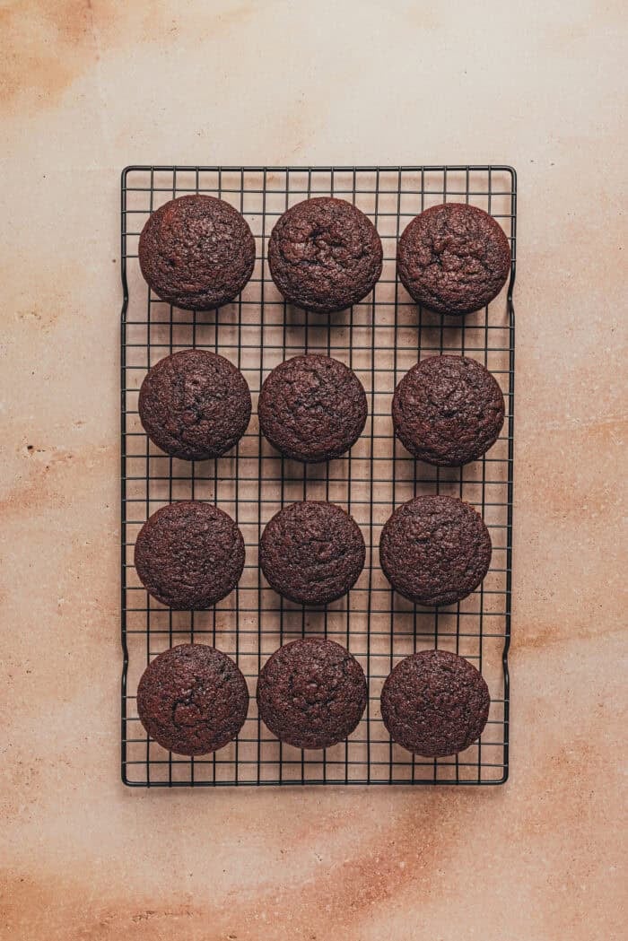 Baked chocolate espresso cupcakes on a cooling rack.