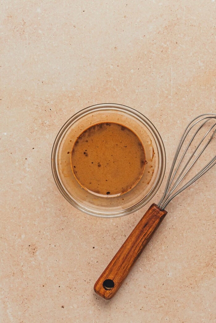 The espresso and half and half mixed together in a glass bowl with a whisk.