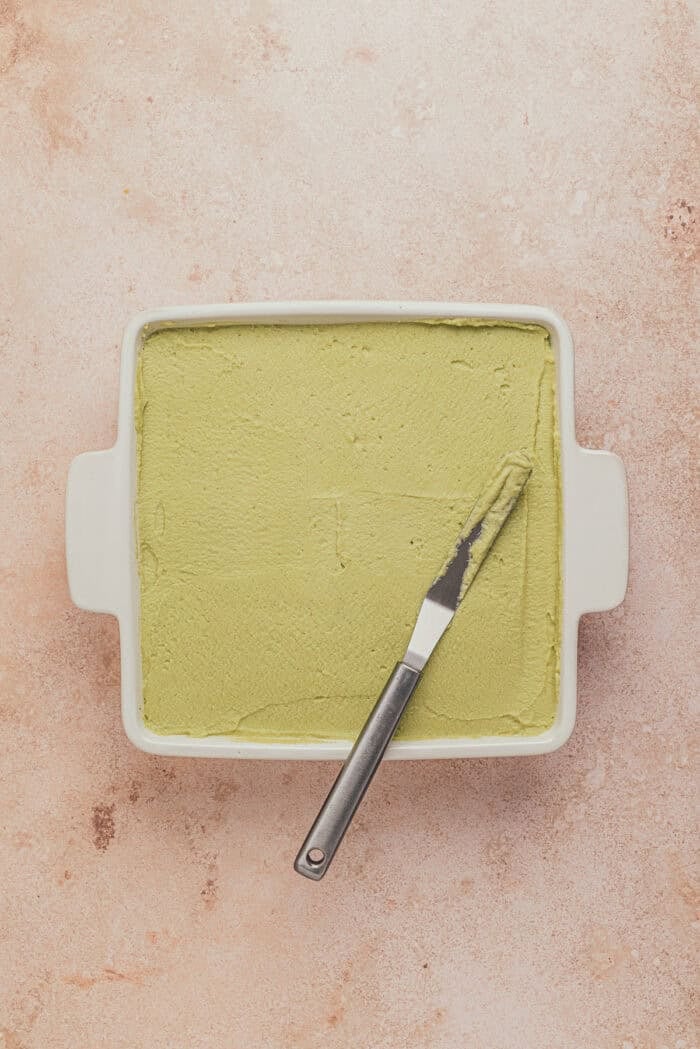 A square pan with pistachio tiramisu without the topping.