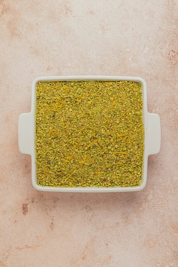 A square pan with pistachio tiramisu.