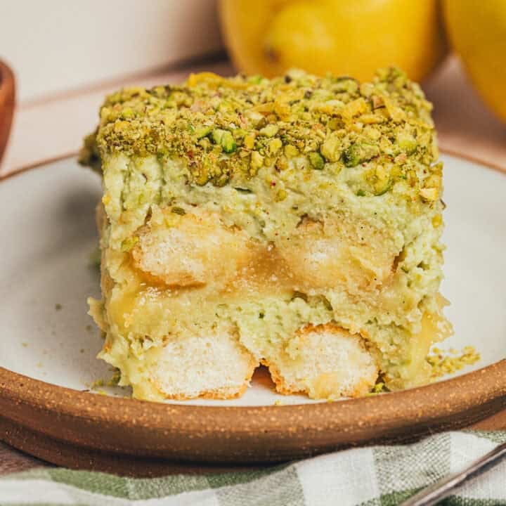 A slice of lemon pistachio tiramisu on a plate.