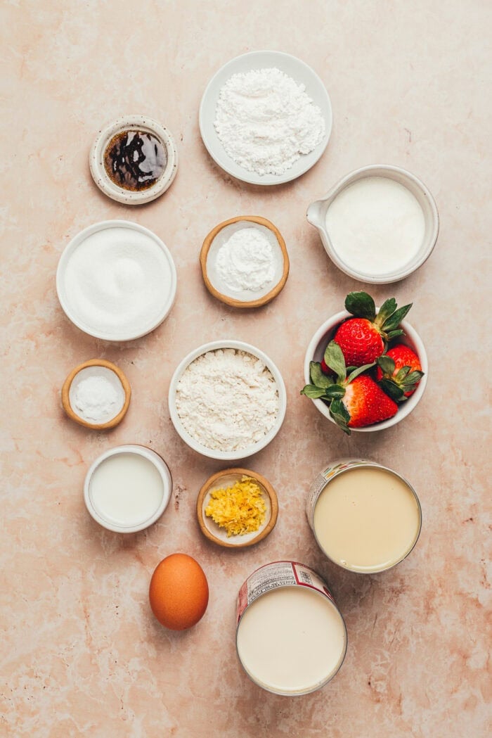 The ingredients needed to make strawberry vanilla bean tres leches cake.