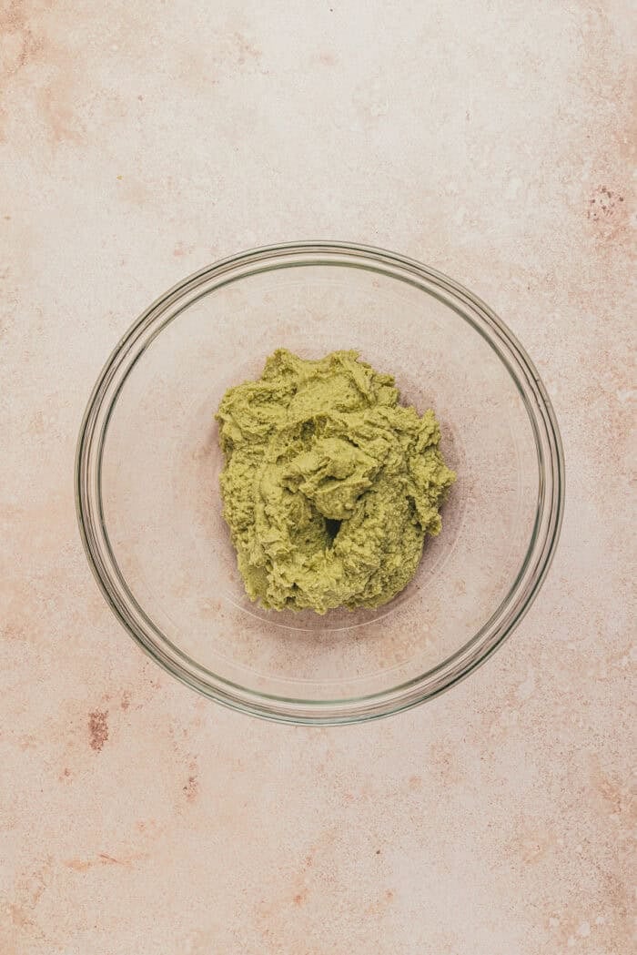 A glass bowl with pistachio and mascapone mixed together.