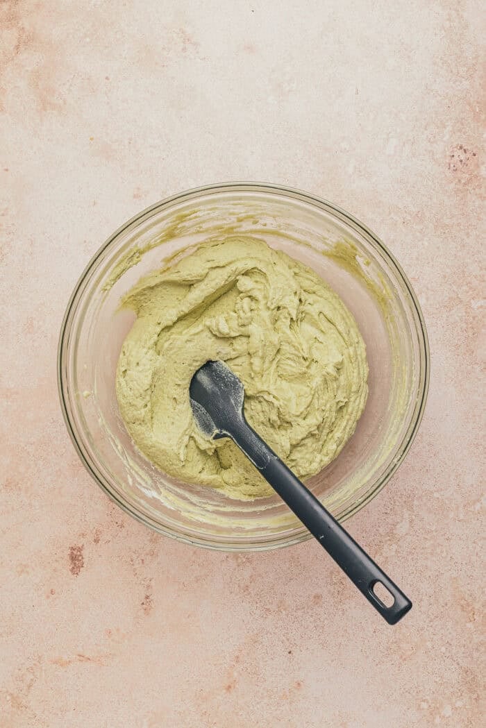 A glass bowl with the whipped cream and pistachio mascarpone combined.
