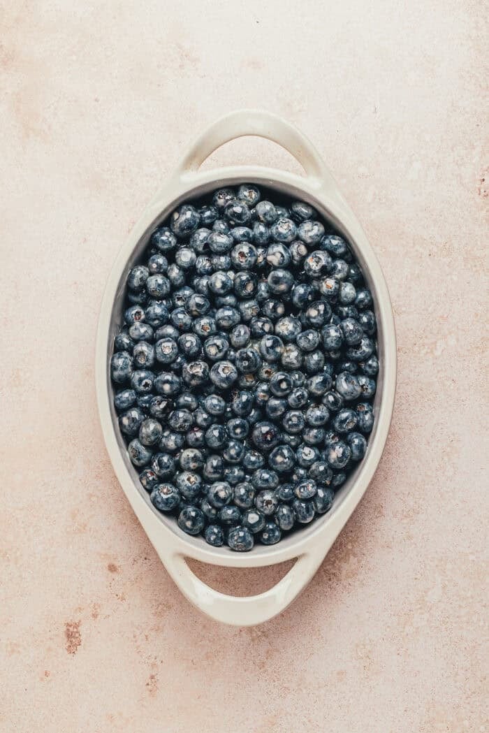 Blueberries in a large oval baking dish.