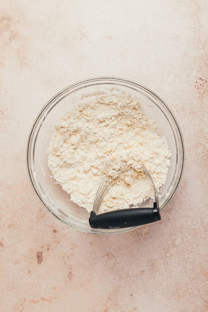 Flour in a glass bowl with a pastry blender.
