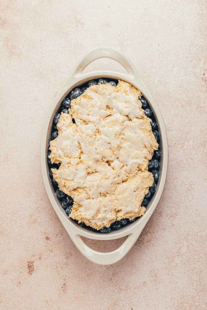 The top of the cobbler brushed with milk and sprinkled with sugar.