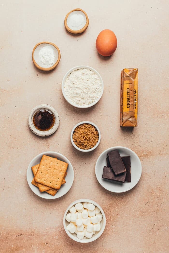 A few bowls with the ingredients needed to make smores bars.