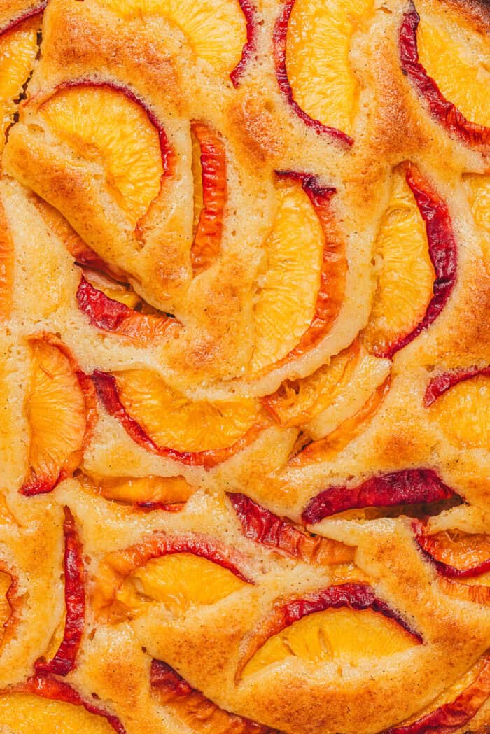 The top view of a peach snack cake showing the sliced peaches.