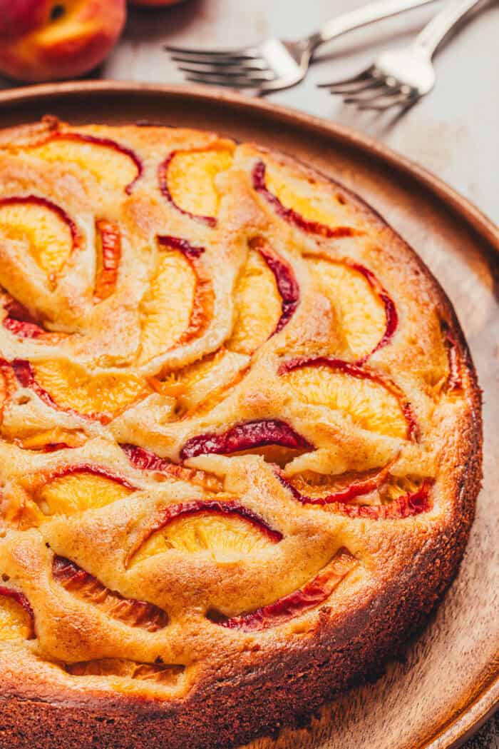 The top view of a homemade peach cake showing the sliced peaches on a platter.