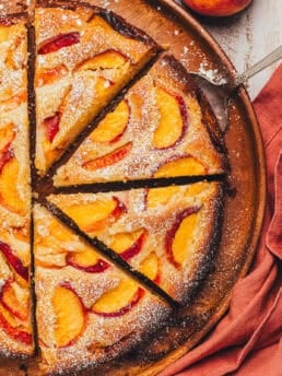 The top view of a peach cake showing the cake slices on a platter.