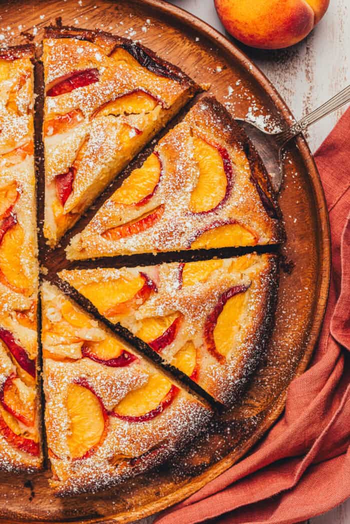 The top view of a peach cake showing the cake slices on a platter.