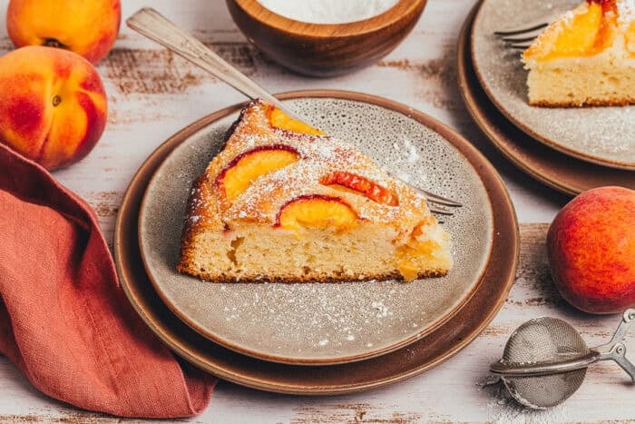 A slice of peach snack cake on a plate.