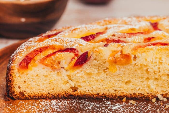 A slice of homemade peach cake on a plate.