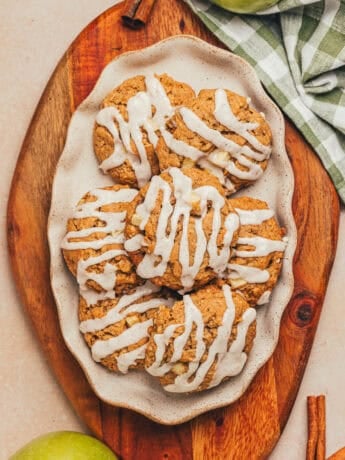 A platter with iced cinnamon apple oatmeal cookies on it.