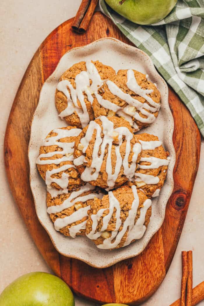 A platter with iced cinnamon apple oatmeal cookies on it.