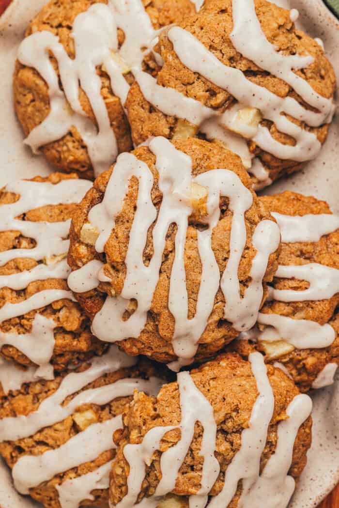 A platter with iced cinnamon apple oatmeal cookies on it.