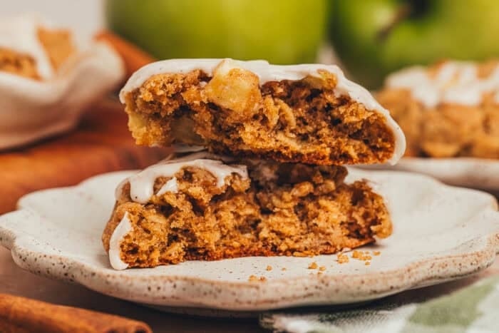 A plate with an apple oatmeal cookie split in half.