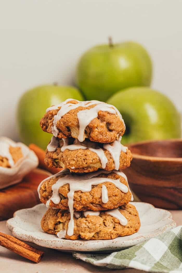 A stack of four apple oatmeal cookies on a plate.