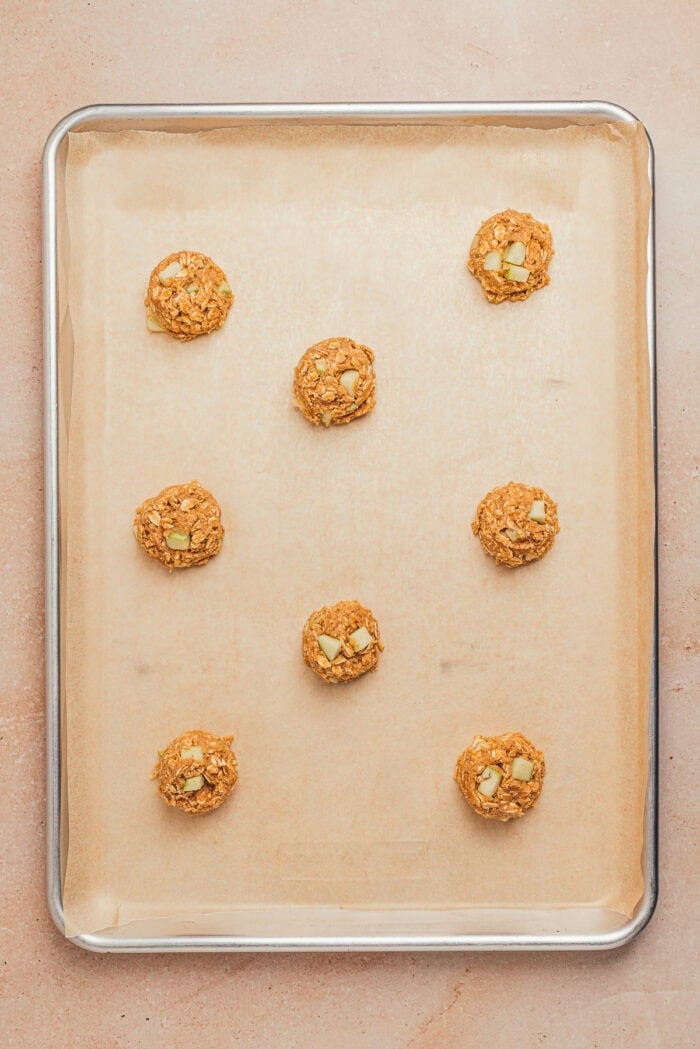 The unbaked cookies on a cookie tray.