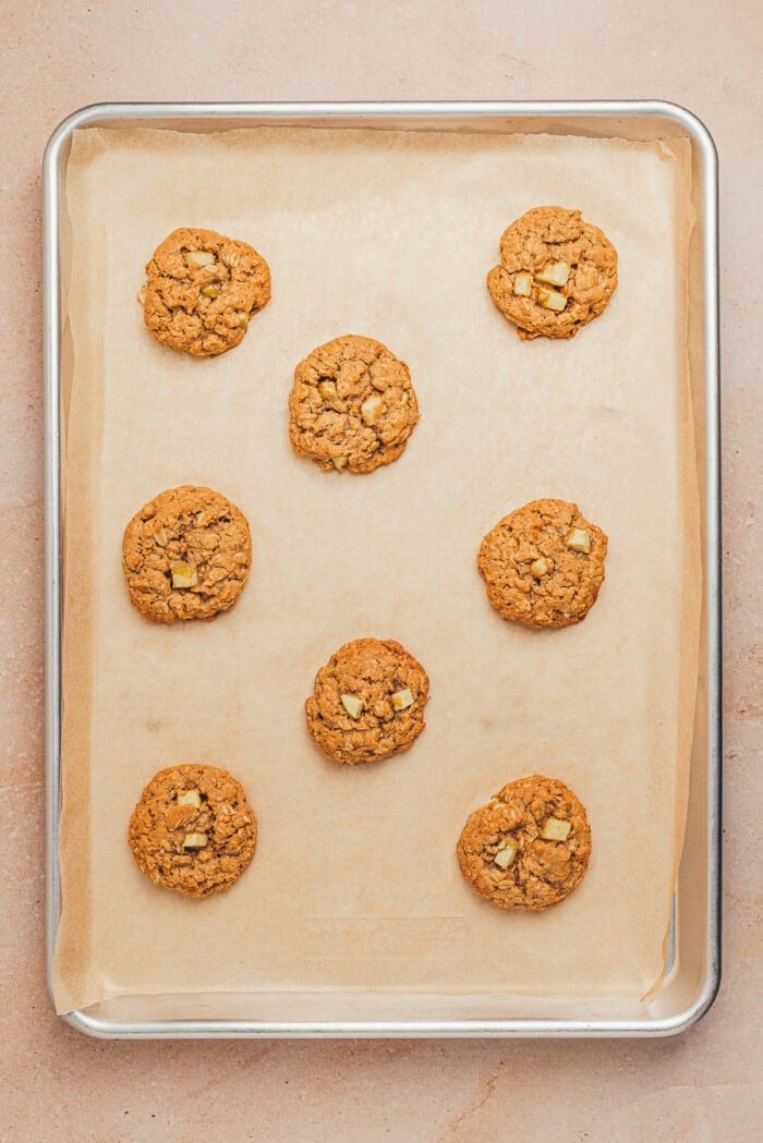 The baked apple oatmeal cookies on a baking tray.