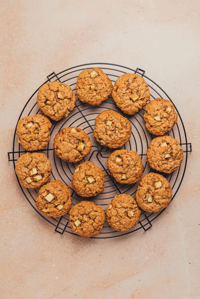 The baked apple oatmeal cookies on a cooling rack.