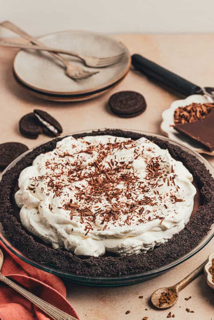 A whole no bake chocolate espresso pie with a napkin and serving utensils.